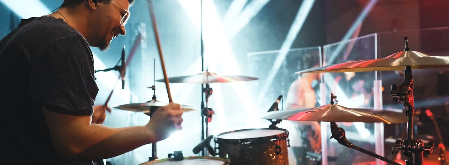 drummer playing in spotlights