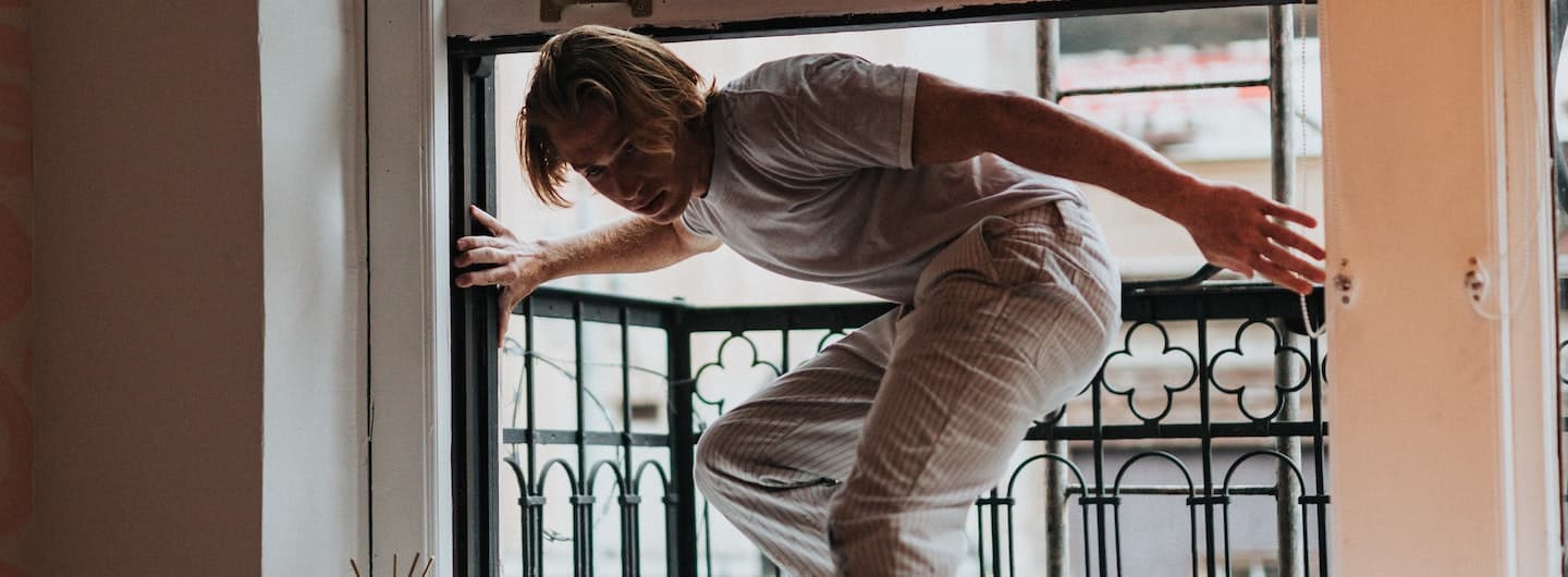 guy crawling through a window