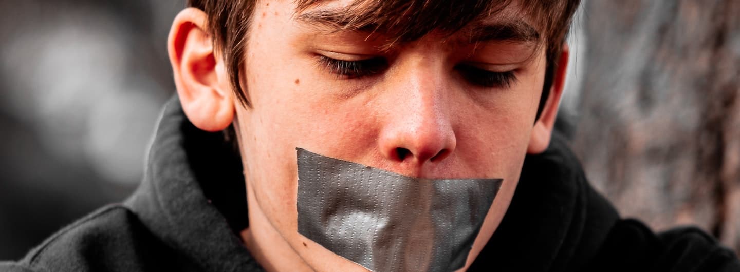 boy with duct tape over his mouth