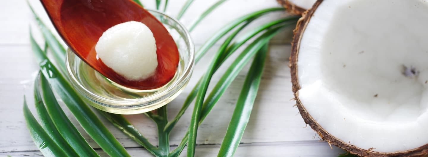 coconut shell with spoon of coconut oil