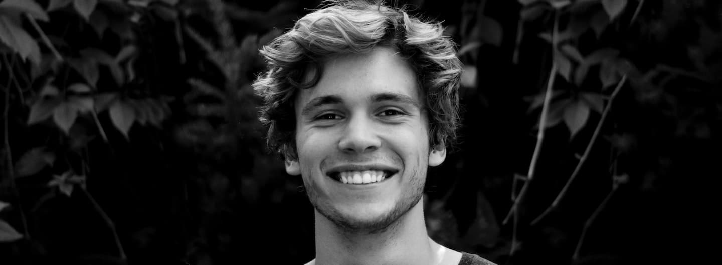 Smiling young guy with wavy hair