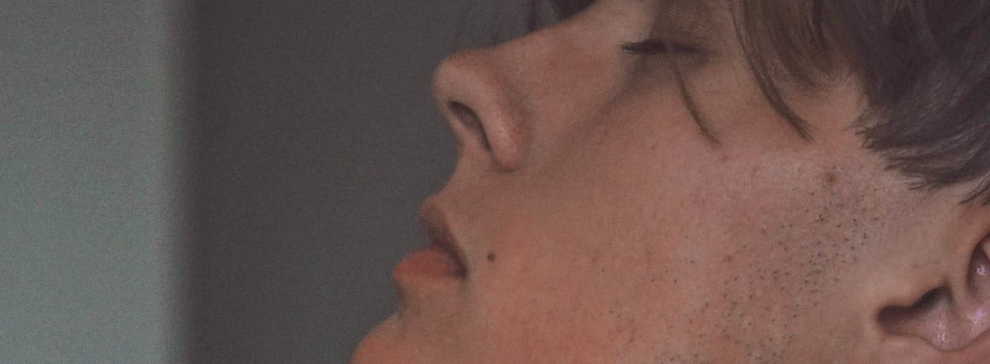 Close-up of a young guy feeling very deeply
