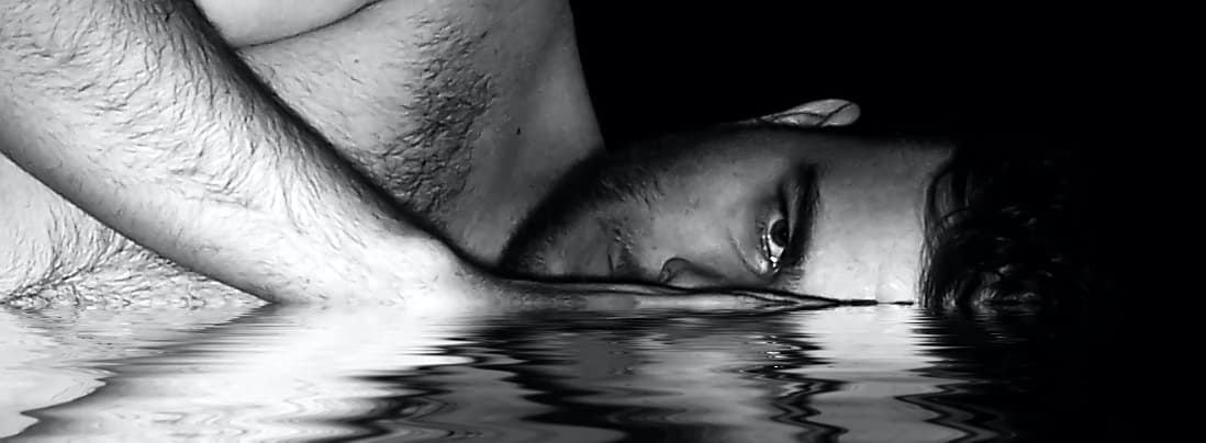 black and white guys face part submerged in water