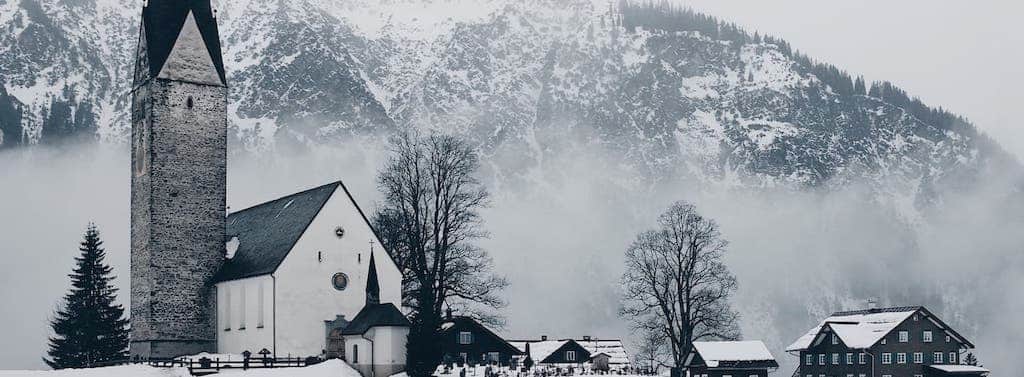 church beneath a snowy mountain